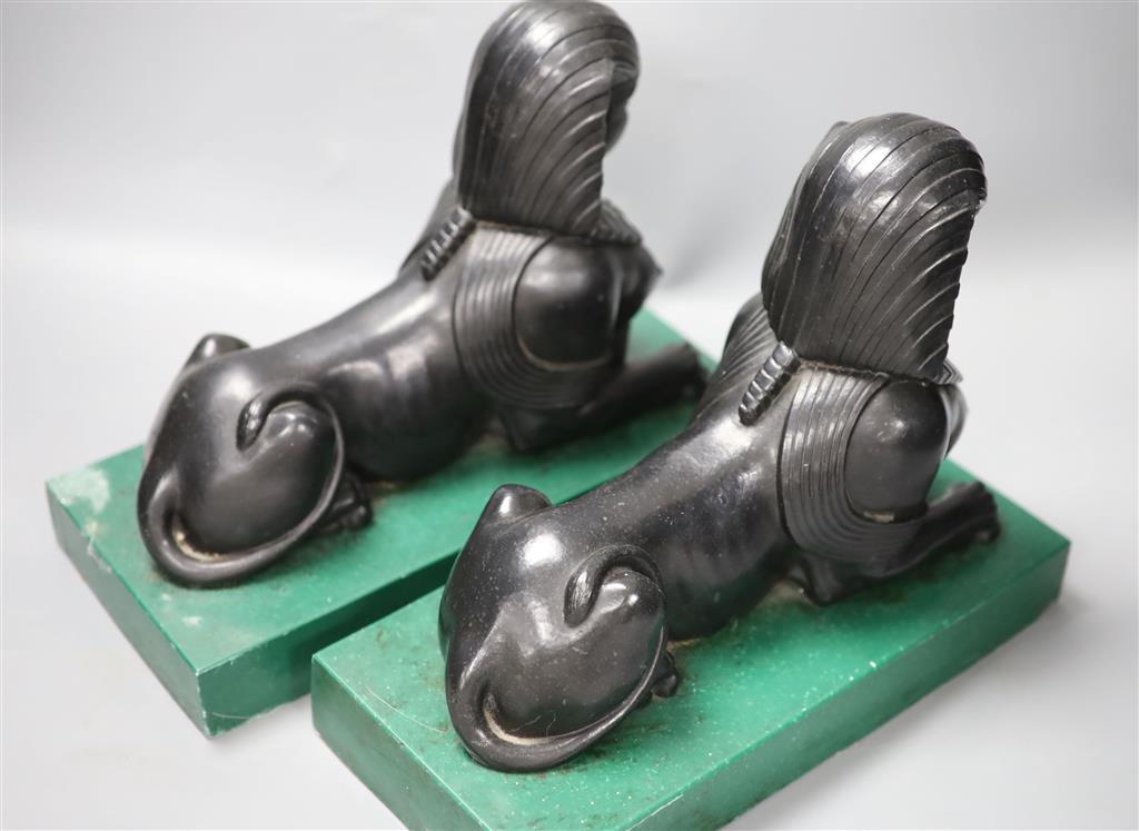 A pair of Egyptianesque composition bookends, each modelled as a Sphinx, width 28cm height 23cm